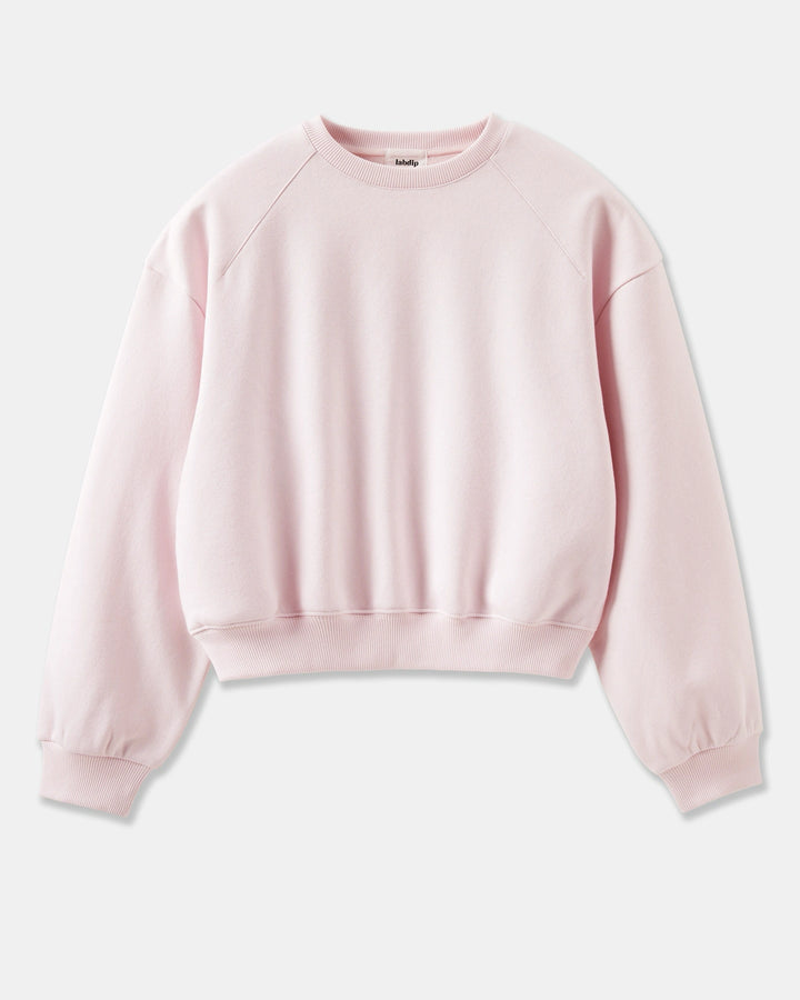 sweat-shirt rose clair en coton doux, coupe ample avec manches longues raglan et bords-côtes aux poignets et à la taille pour un style confortable et décontracté