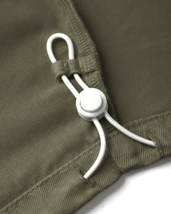 Détail d'un pantalon femme khaki en Tencel avec un cordon de serrage blanc ajustable, tissu fluide et doux au toucher, coupe confortable et adaptée à toutes les morphologies.