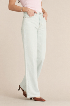 Jean femme en denim 100% coton bleu clair légèrement blanchâtre, coupe large et flare, offrant un confort décontracté adapté à toutes les morphologies.