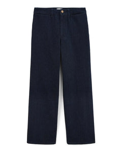 Jean femme en denim brut 100 % coton, coupe large et droite, couleur indigo foncé, matière rigide et structurée, idéal pour toutes les morphologies.