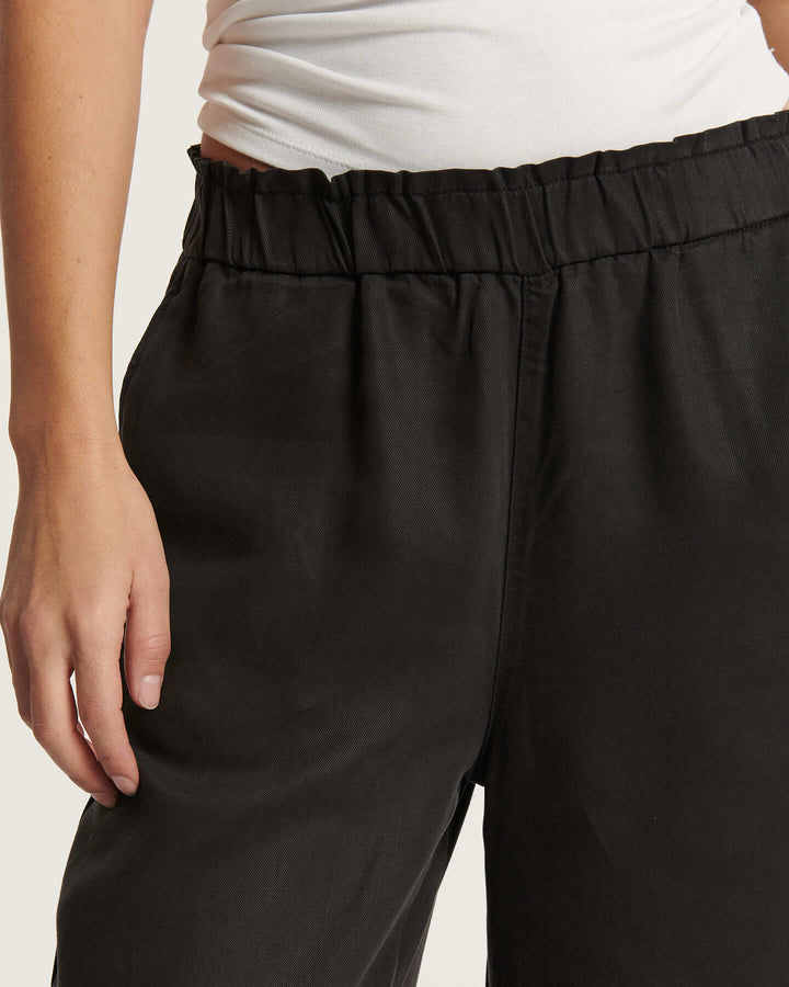 Pantalon noir en tissu Tencel fluide avec taille élastique, coupe droite ample qui s'adapte parfaitement à toutes les morphologies féminines.