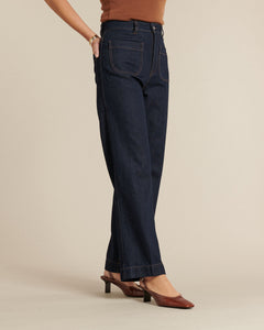 Jean en denim brut 100 % coton, coupe droite légèrement ample, couleur bleu foncé avec coutures contrastantes, offrant un confort adapté à toutes les morphologies féminines.