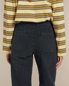 Jean droit en denim 100% coton de couleur bleu foncé, coupe taille haute avec poches arrière carrées, conçu pour s’adapter à diverses morphologies féminines.